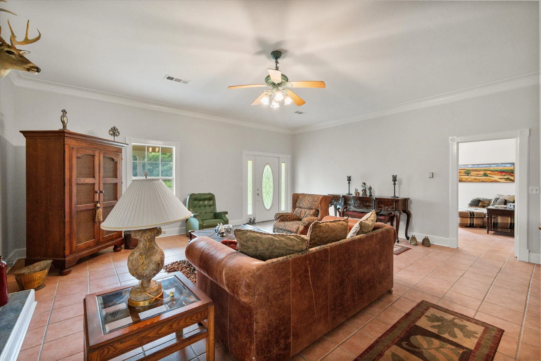 Comfortable living space with fireplace, tile flooring, and open connection to kitchen and dining areas.