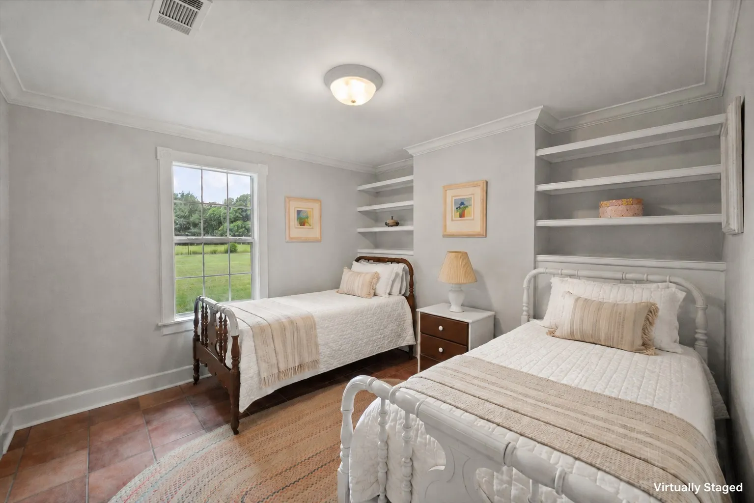 Bedroom with twin beds, farmhouse bedding, and built-in shelving in Kerens TX country home.
