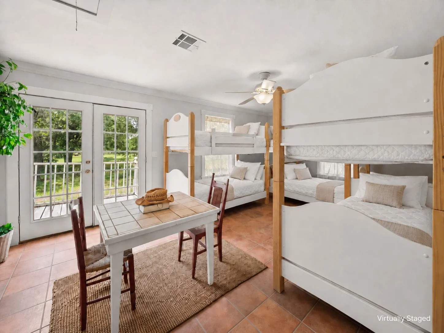 Bunkroom with six twin beds, farmhouse bedding, and flexible guest space near Corsicana.
