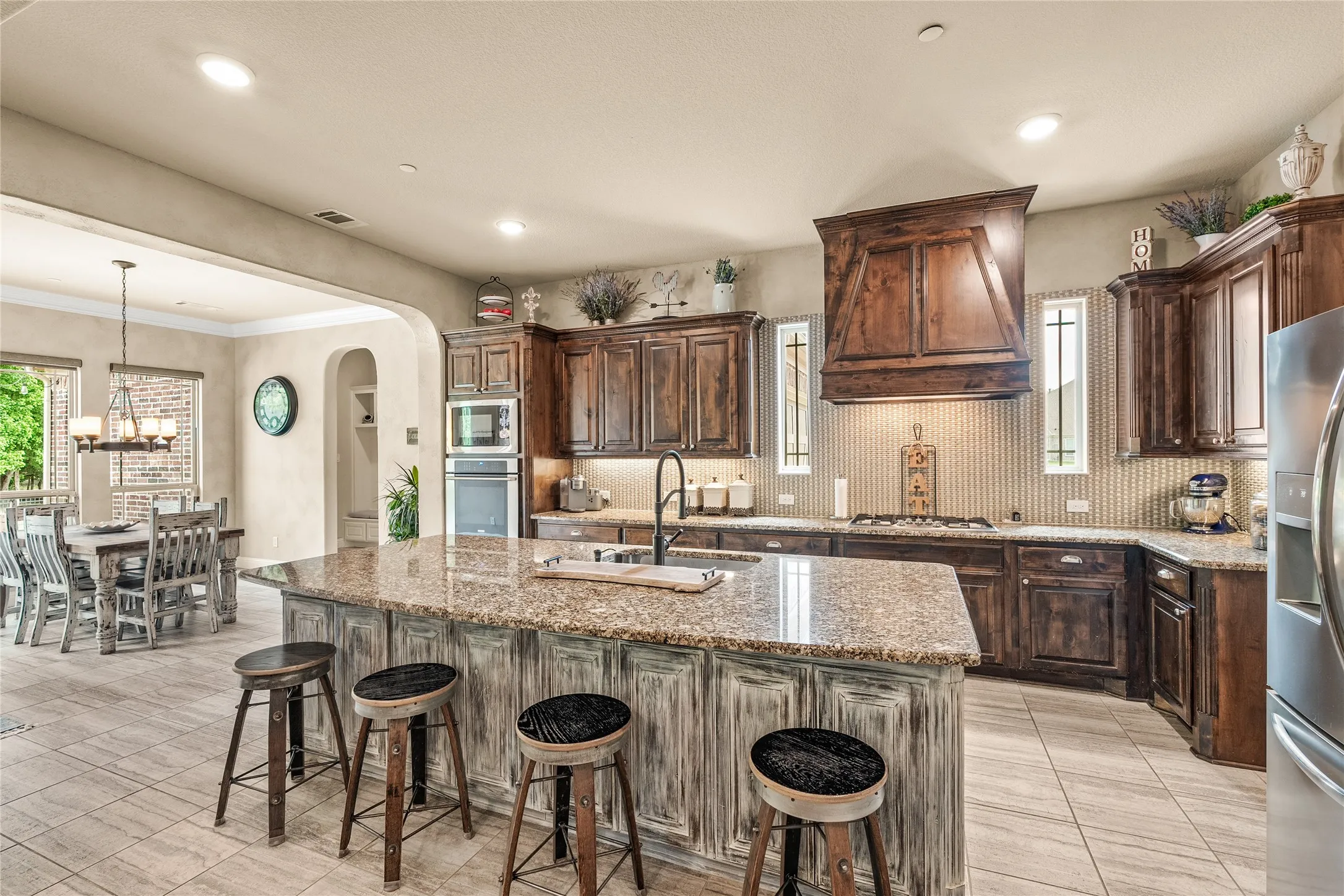 beautiful wood cabinetry with gas cooktop and 2 ovens