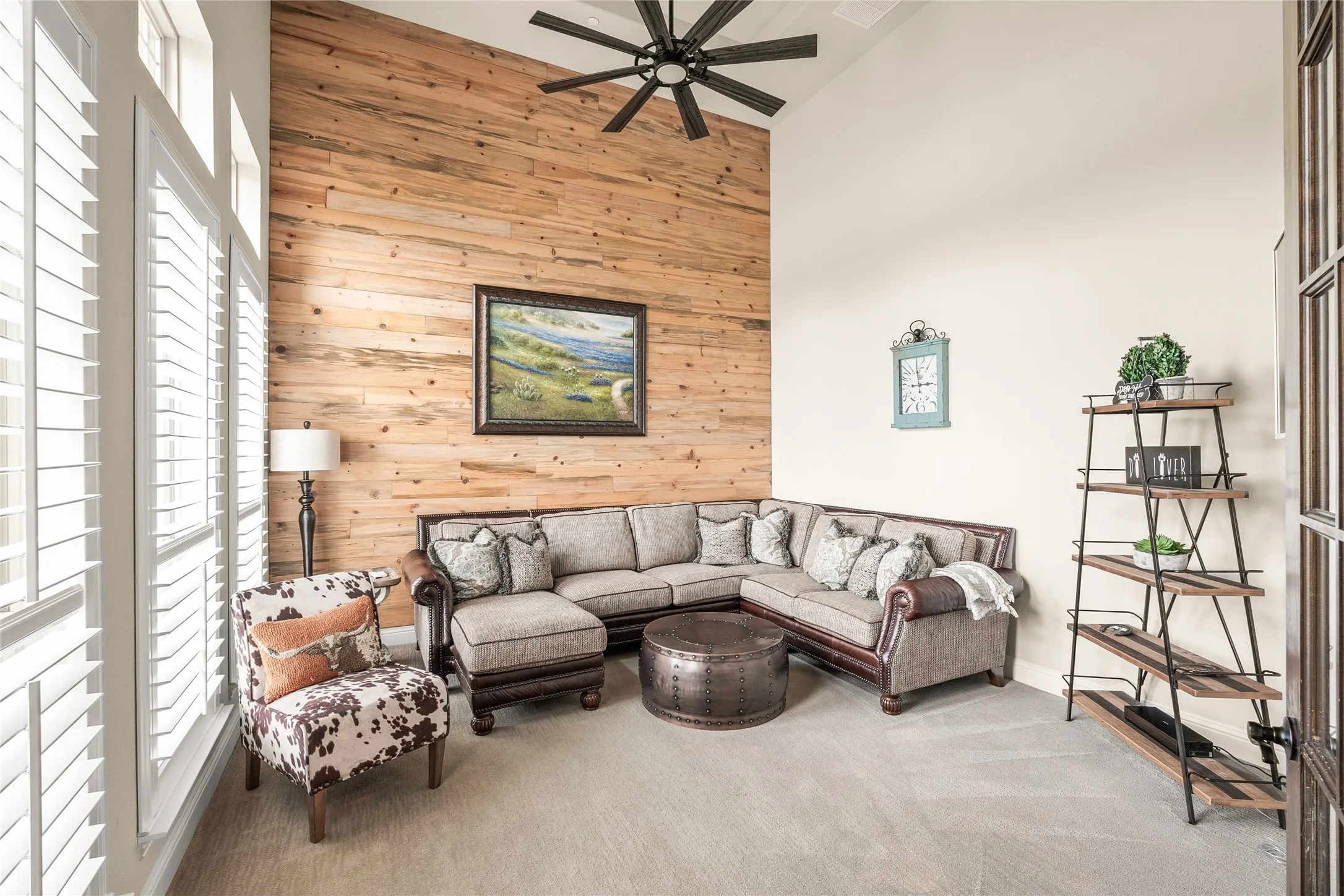 spacious office with natural wood accent wall, and high trey ceiling