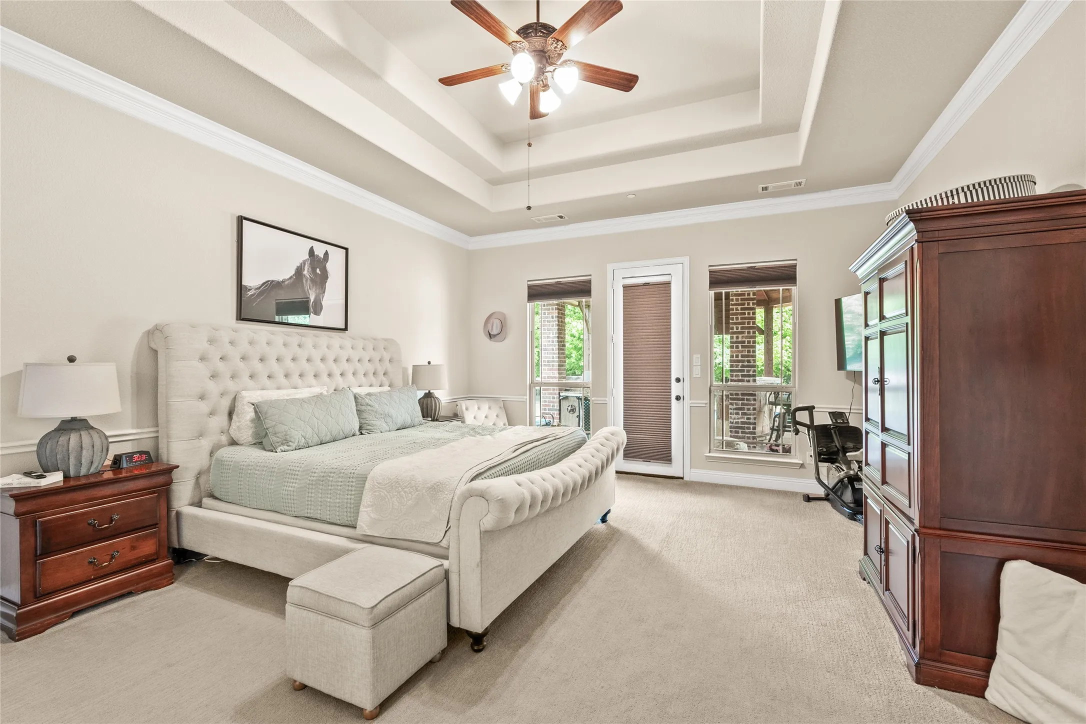 Spacious primary with trey celing and door to backyard