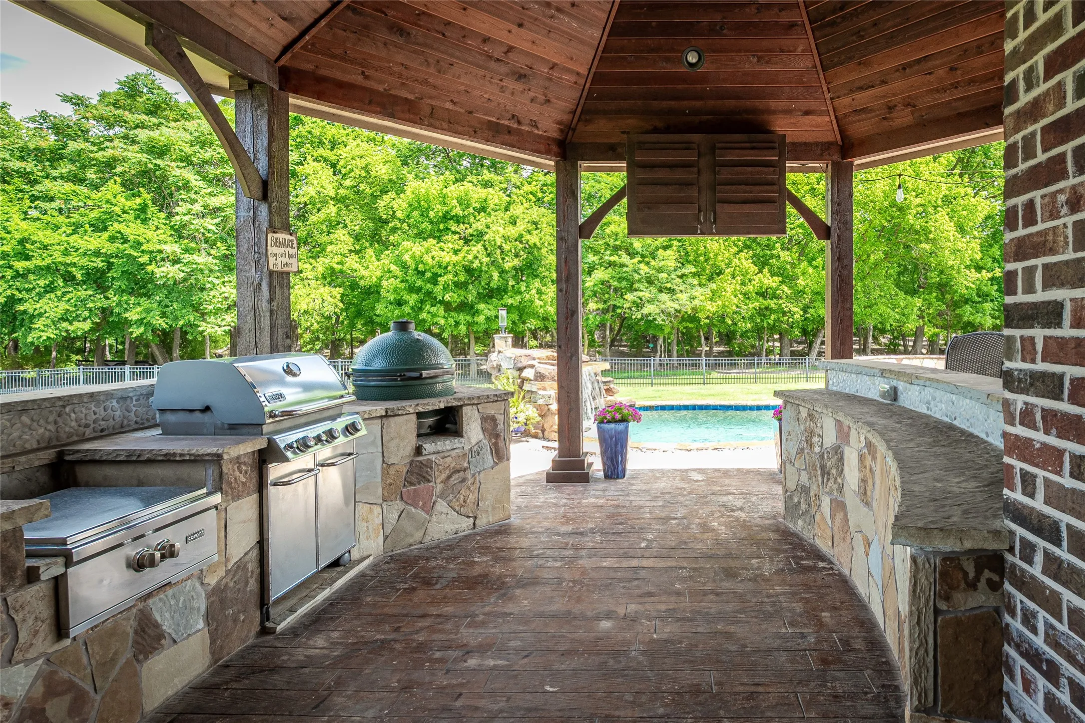 outdoor kitchen with gas grill, green egg and television
