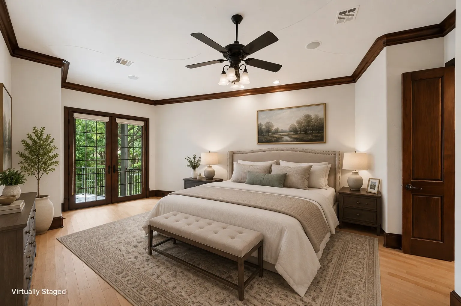 Hardwood flooring throughout, double French doors with exterior balcony access, dark wood trim and crown molding, ceiling fan with integrated lighting, and recessed ceiling speakers