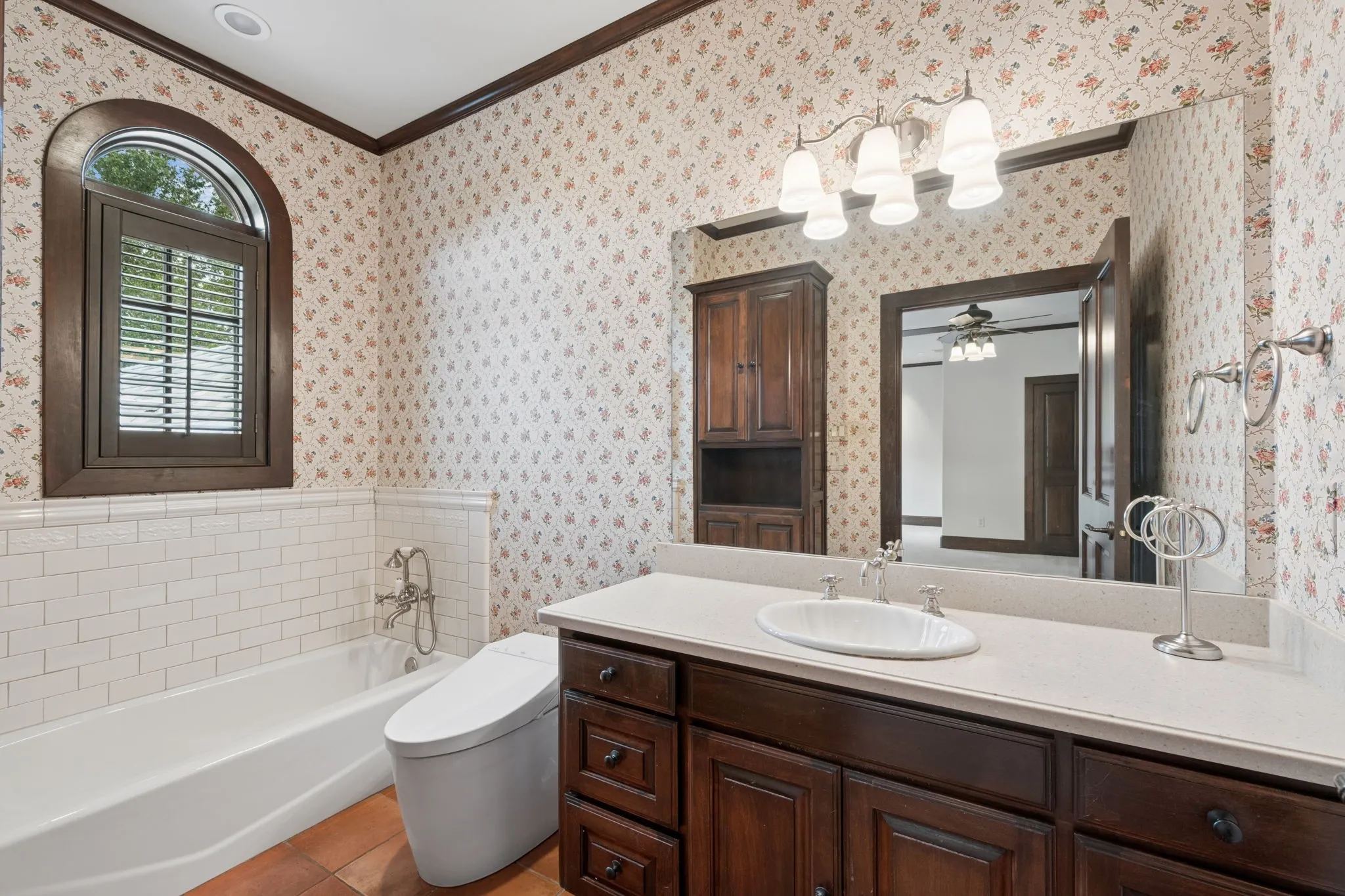 Second floor bathroom featuring a dark wood vanity with a light-toned countertop, an undermount sink, and a large wall-mounted mirror