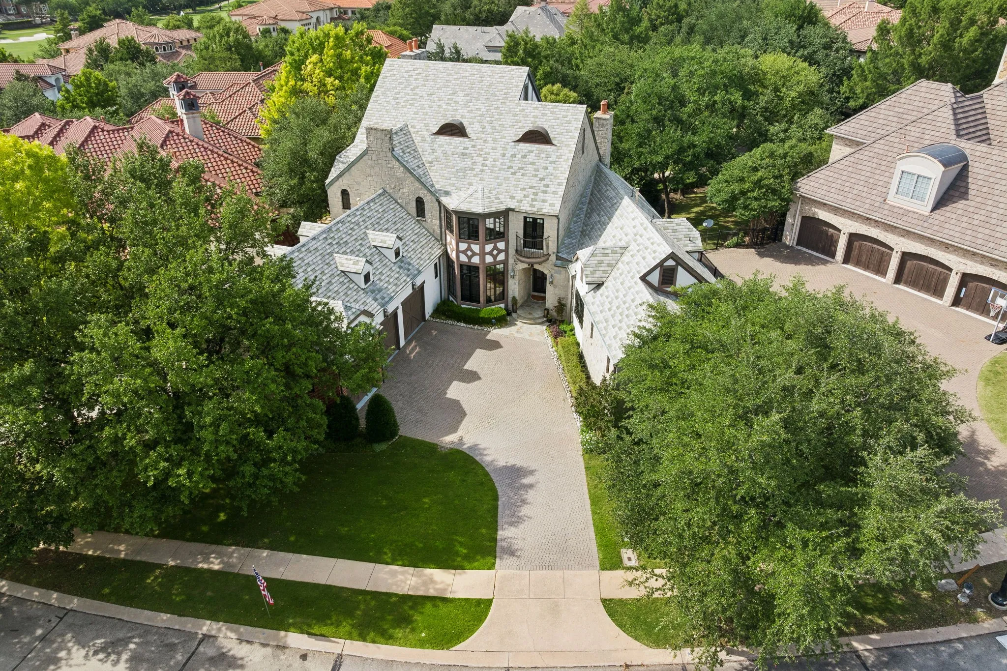Stone and stucco exterior with a multi-gabled roof and dormer windows