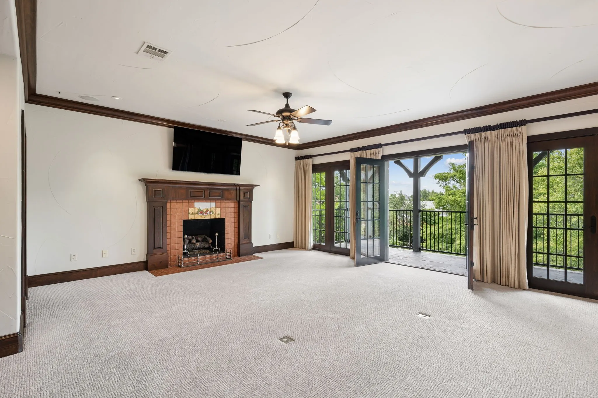 2nd floor game room with French doors to covered balcony
