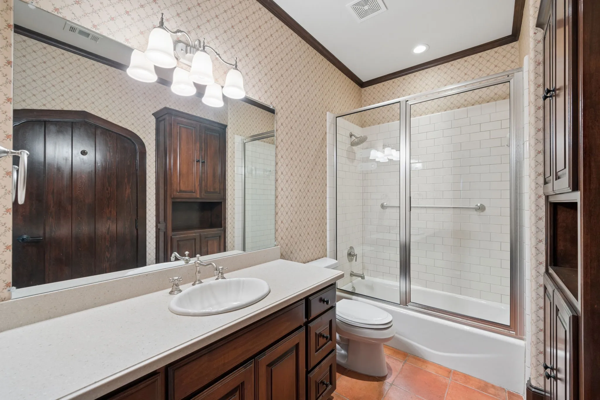 Second floor bathroom featuring a single vanity with an oval sink, light-colored countertop, and dark wood cabinetry