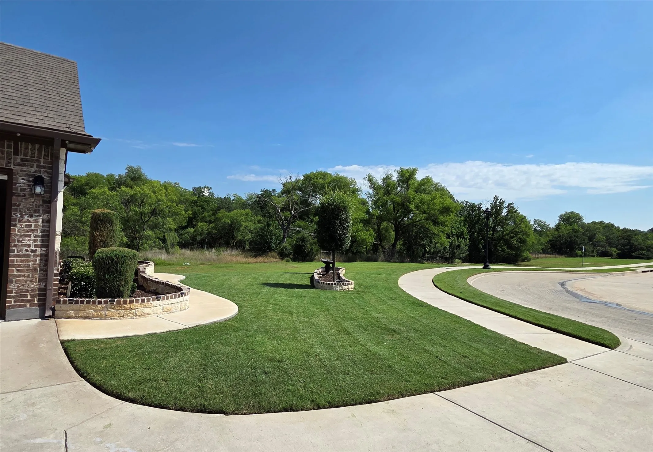 Expansive green lawn with mature perimeter trees