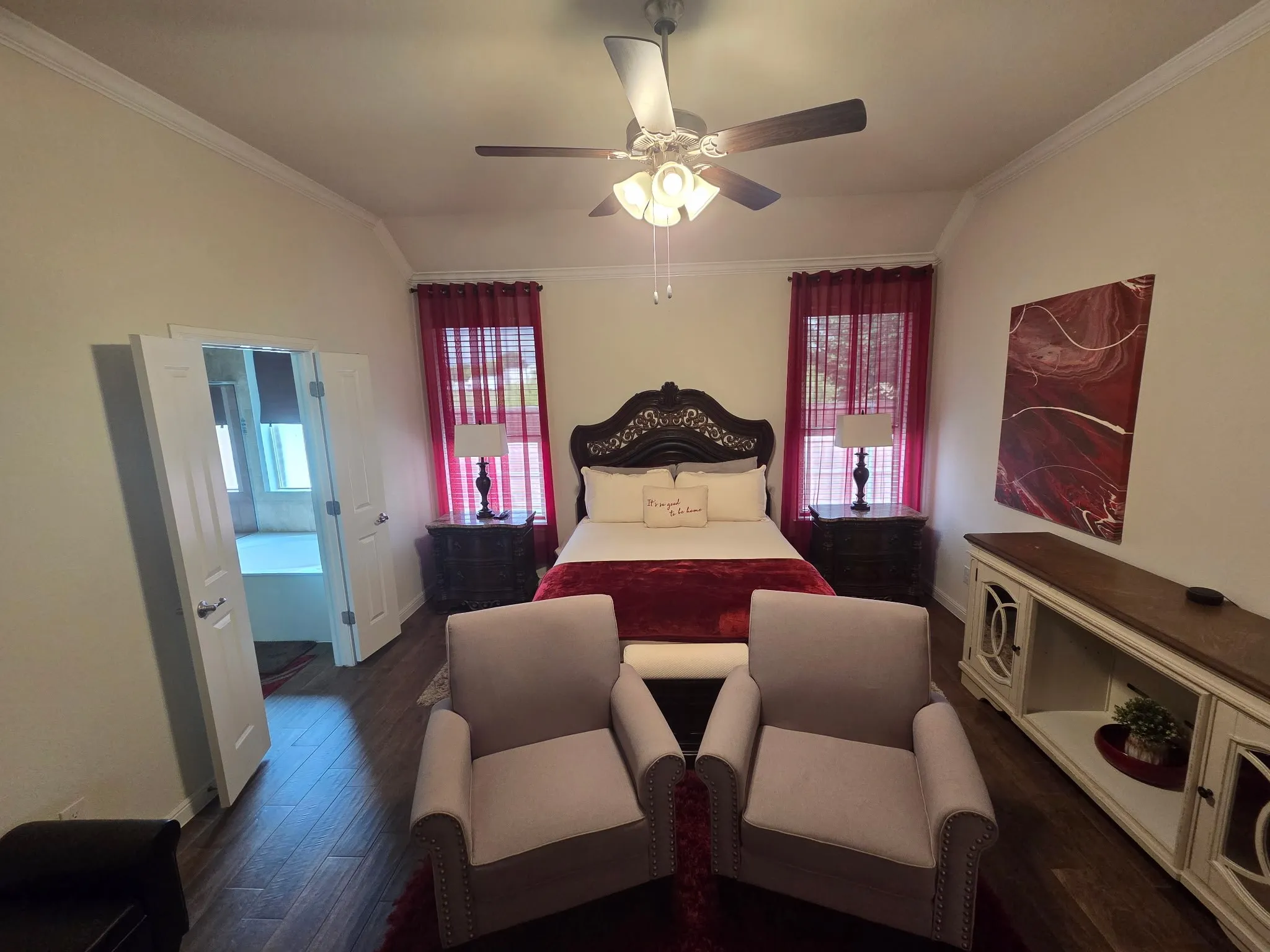 Spacious room featuring ceramic tile wood-finish flooring, a tray ceiling, crown molding, and a ceiling fan with integrated lighting