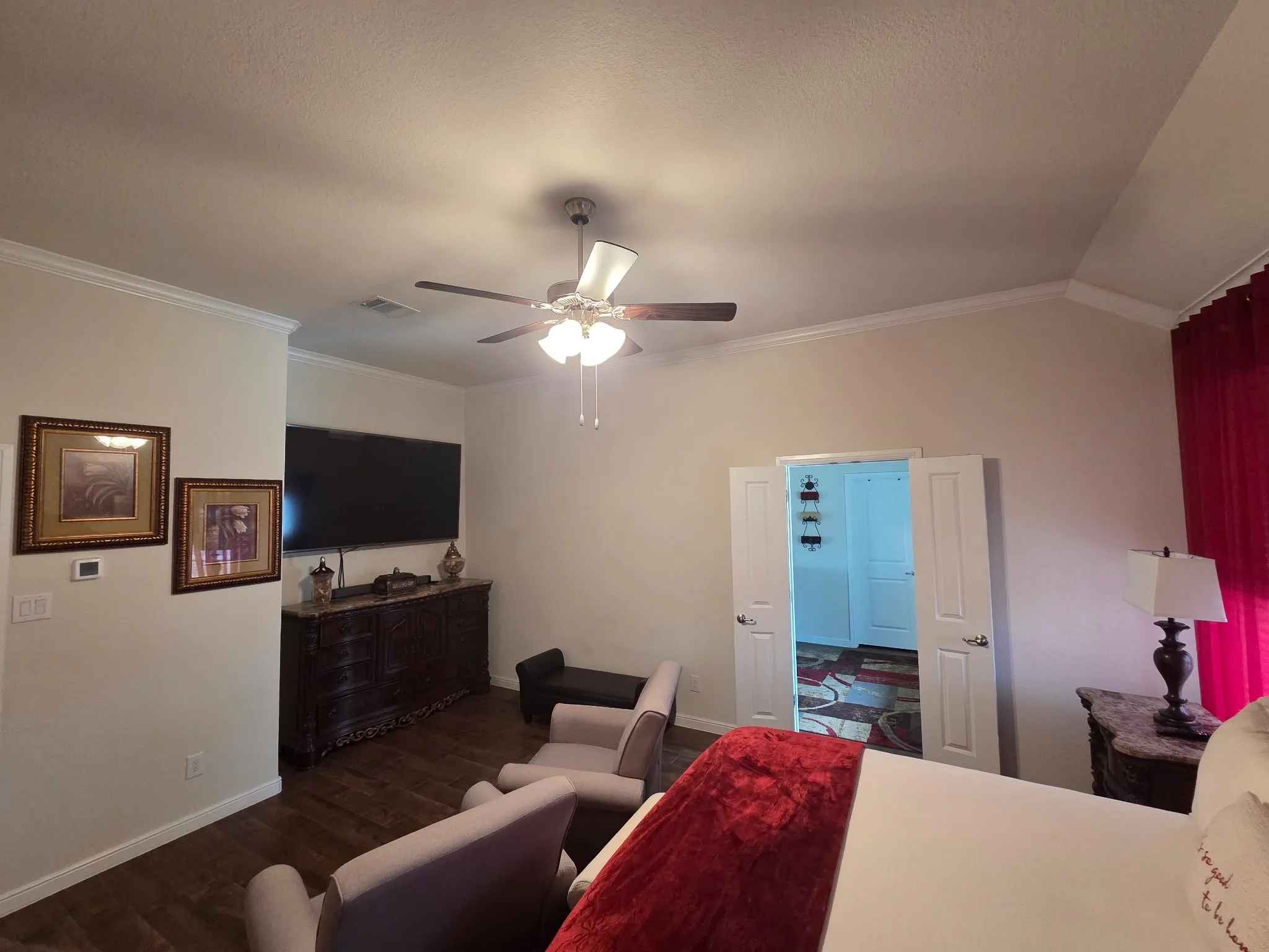 Spacious interior with crown molding and wood-finish flooring