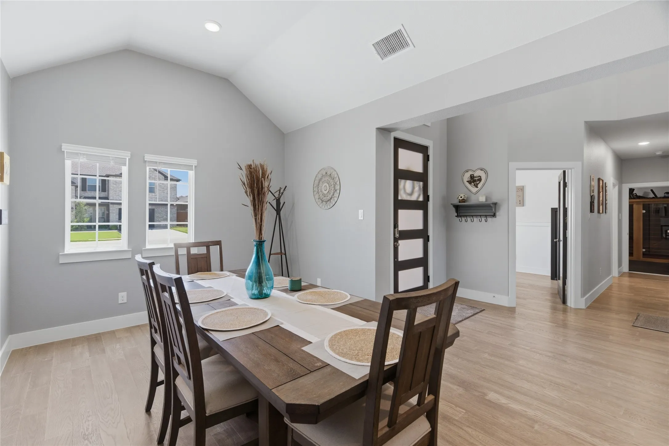 Dining area showing entry, door to office, and hallway that leads to full bath, laundry and media room
