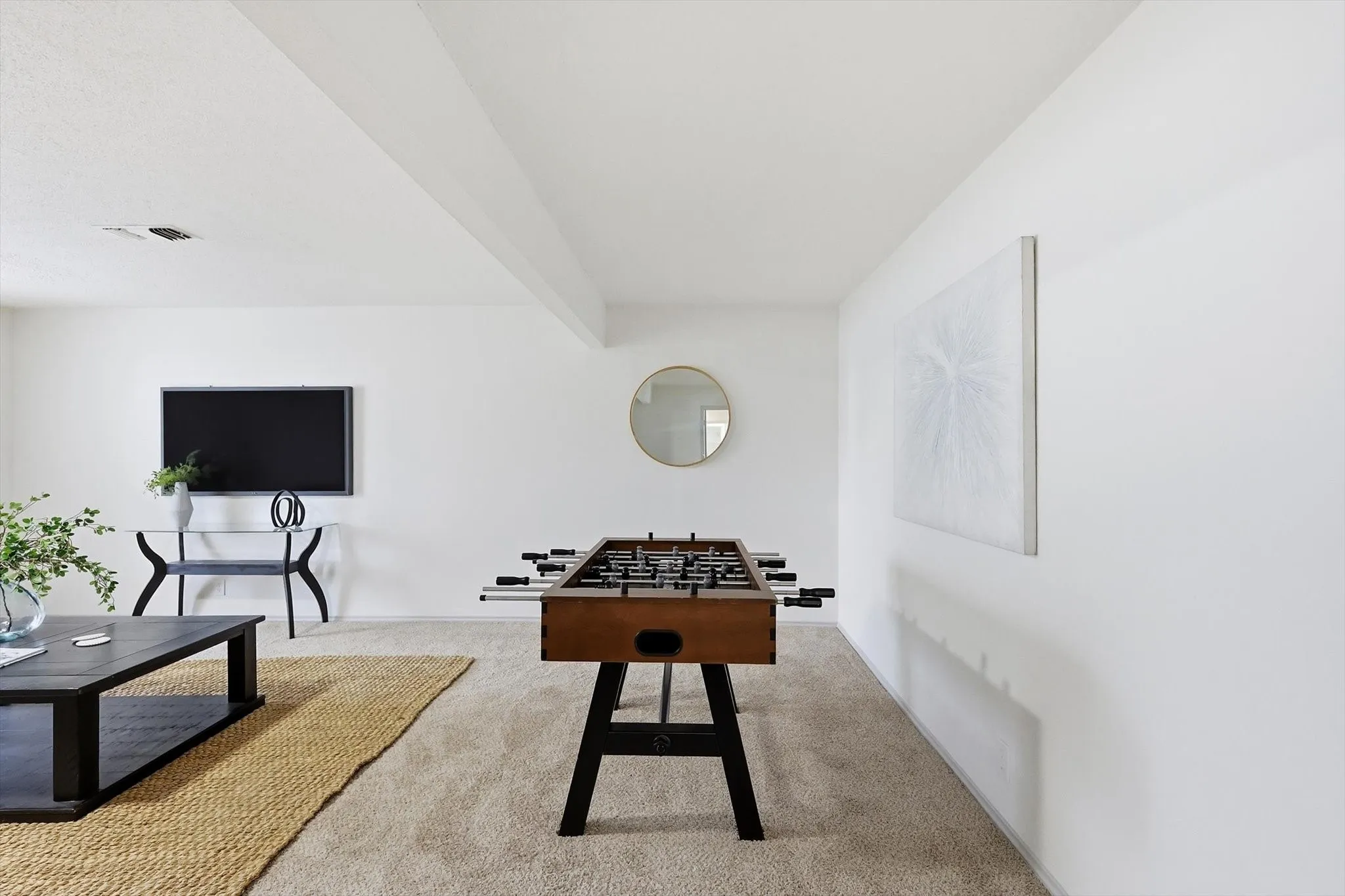 Spacious room featuring neutral carpeting and white walls