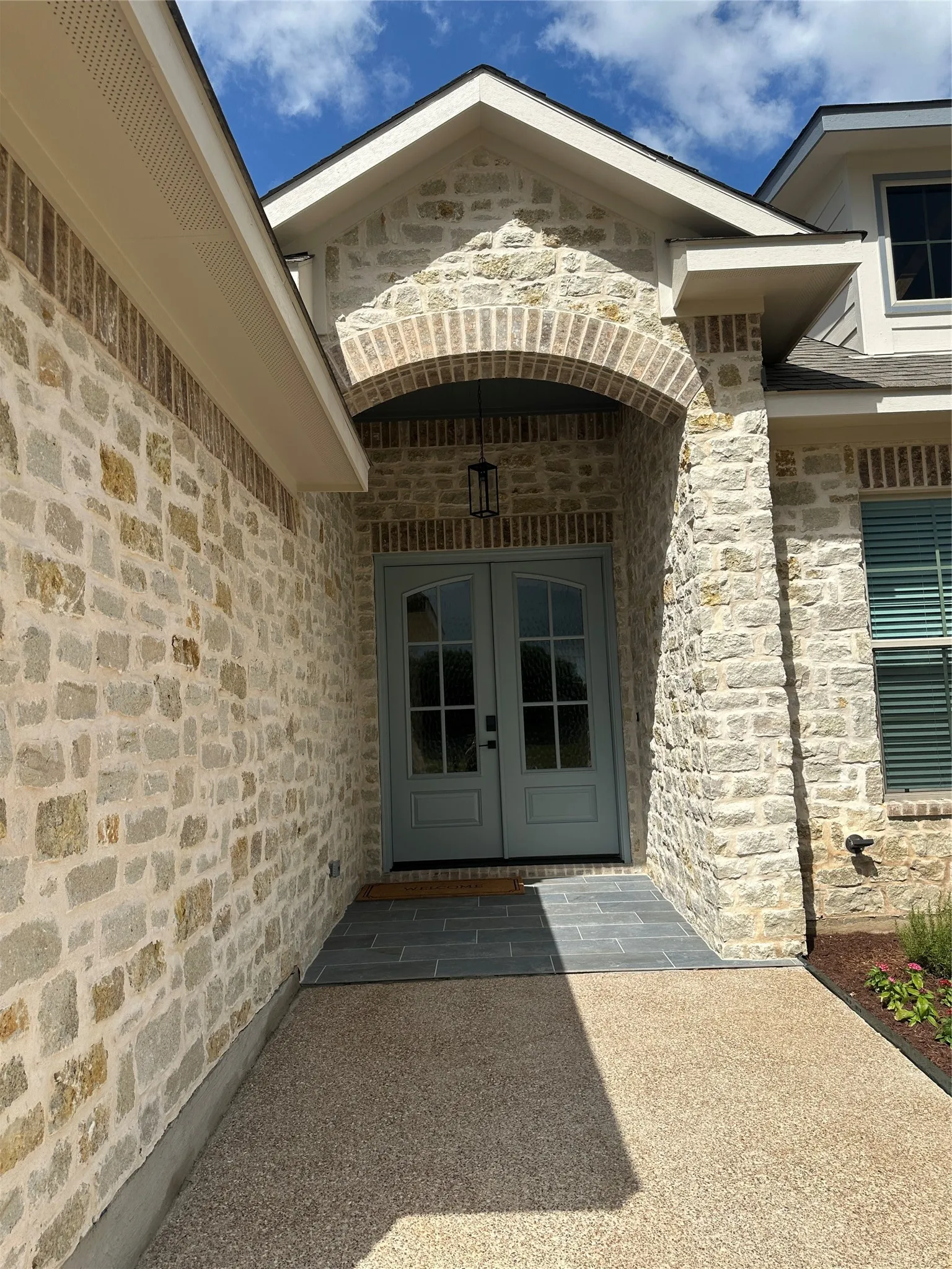 Stone veneer exterior with brick archway detailing