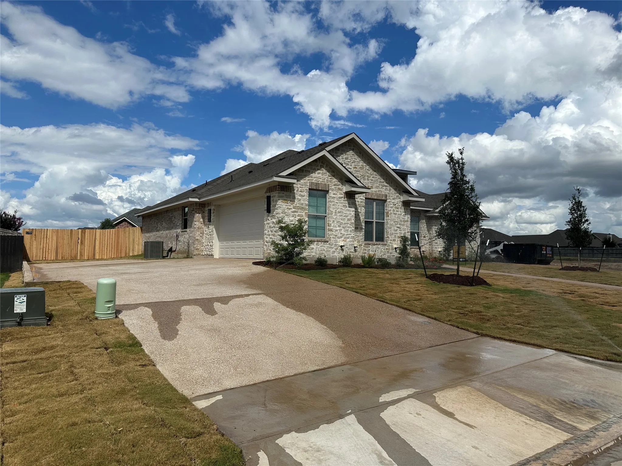 Stone and brick exterior with a two-car garage