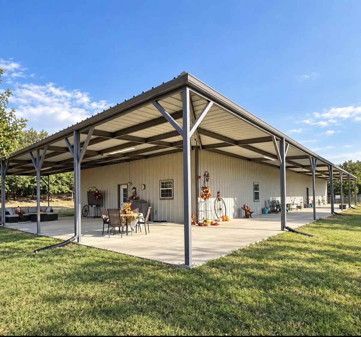 Expansive covered patio with concrete flooring, metal roof, and integrated gutter system