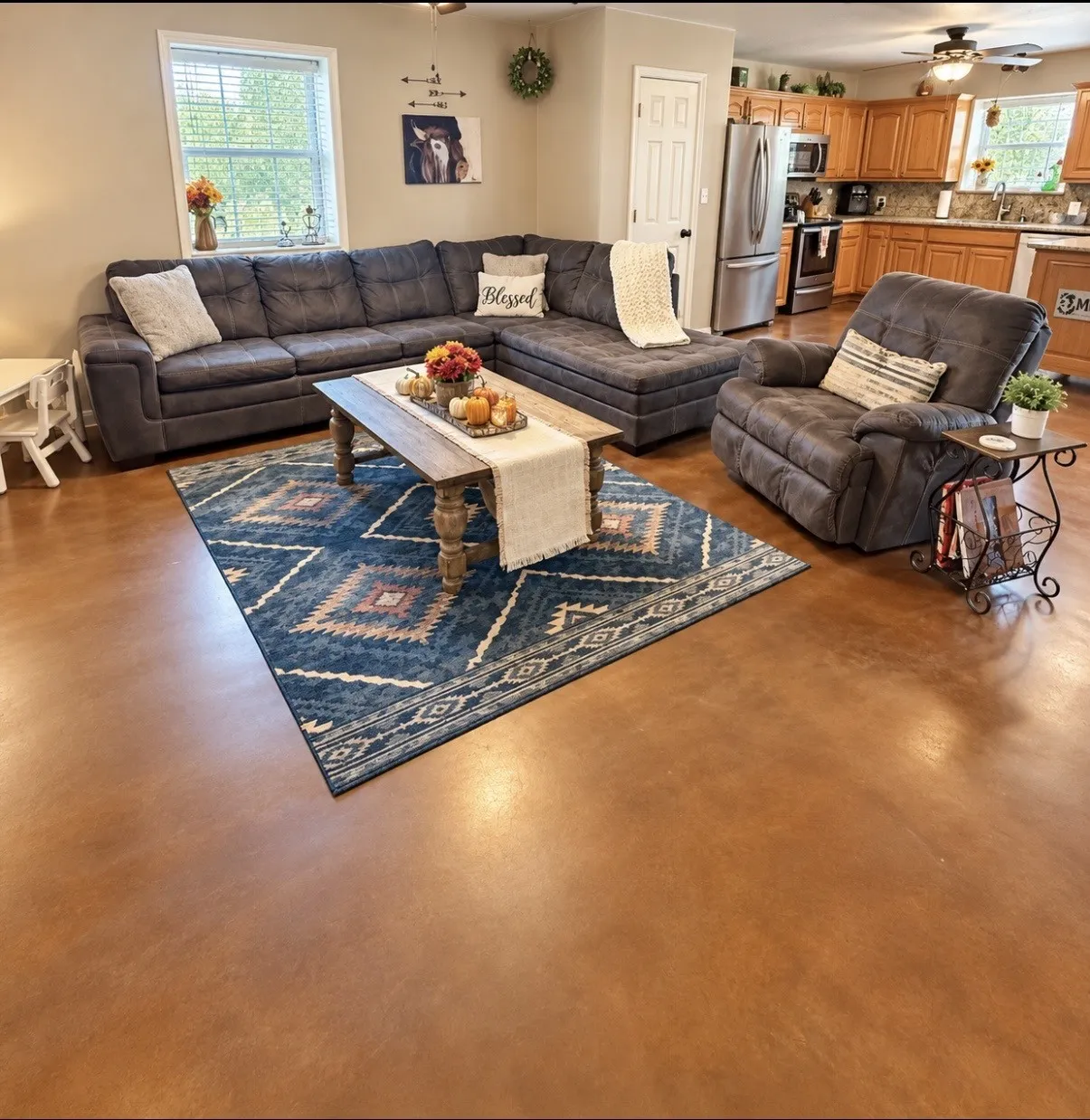  Open-concept living area featuring rich brown flooring and incredible space