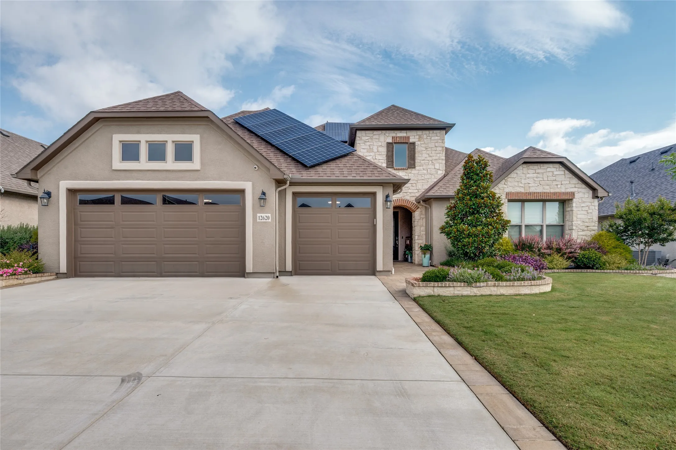 Pavers, and lifted flower beds welcome you inside.