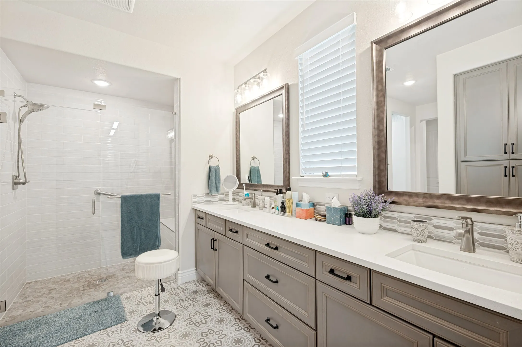 Wow! Zero Entry frameless shower, tasteful tile floor and mushroom colored cabinetry.