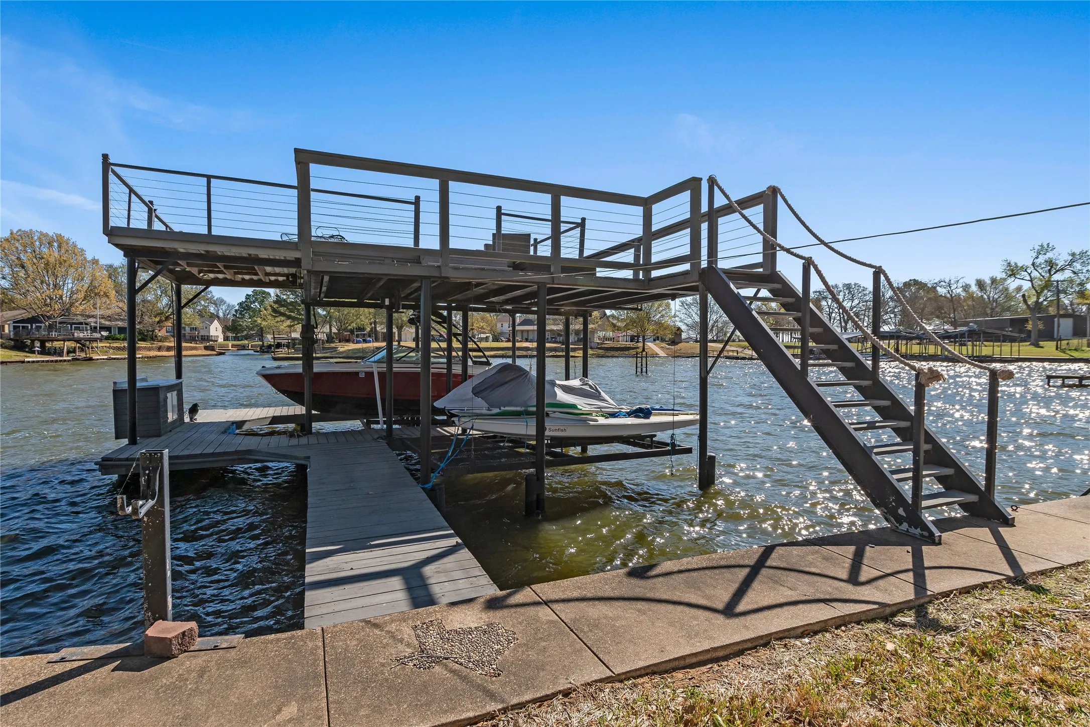 Dock featuring boat lift and a water view