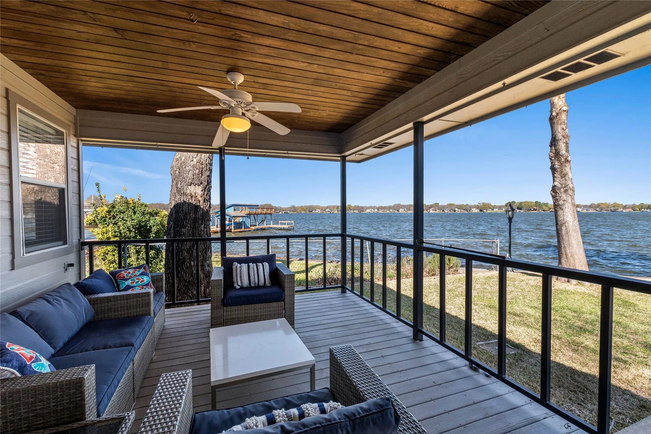Sunroom featuring an outdoor hangout area, a water view, and a ceiling fan