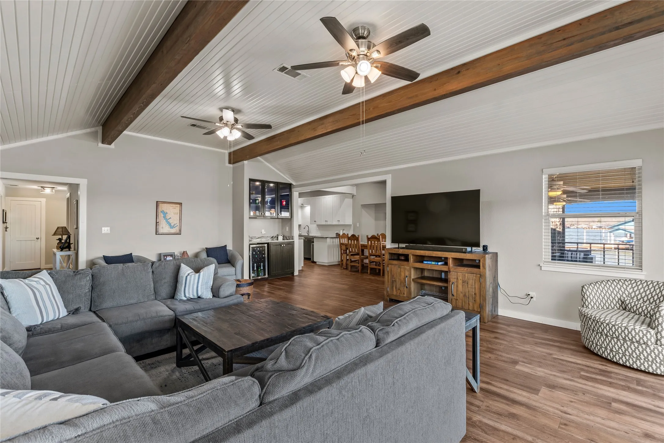 Living area with wood finished floors, beverage cooler, and bar area