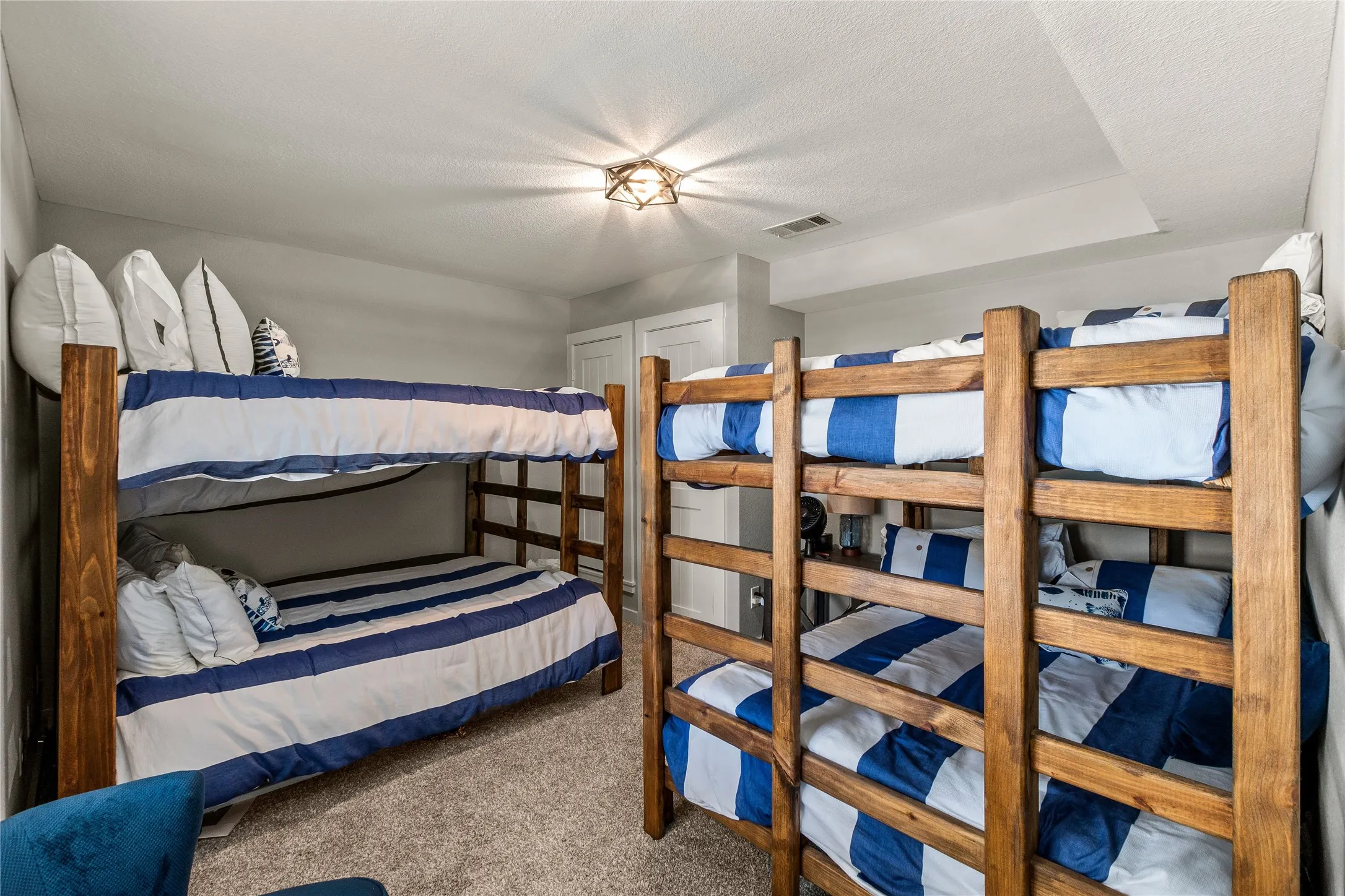 Carpeted bedroom with a textured ceiling