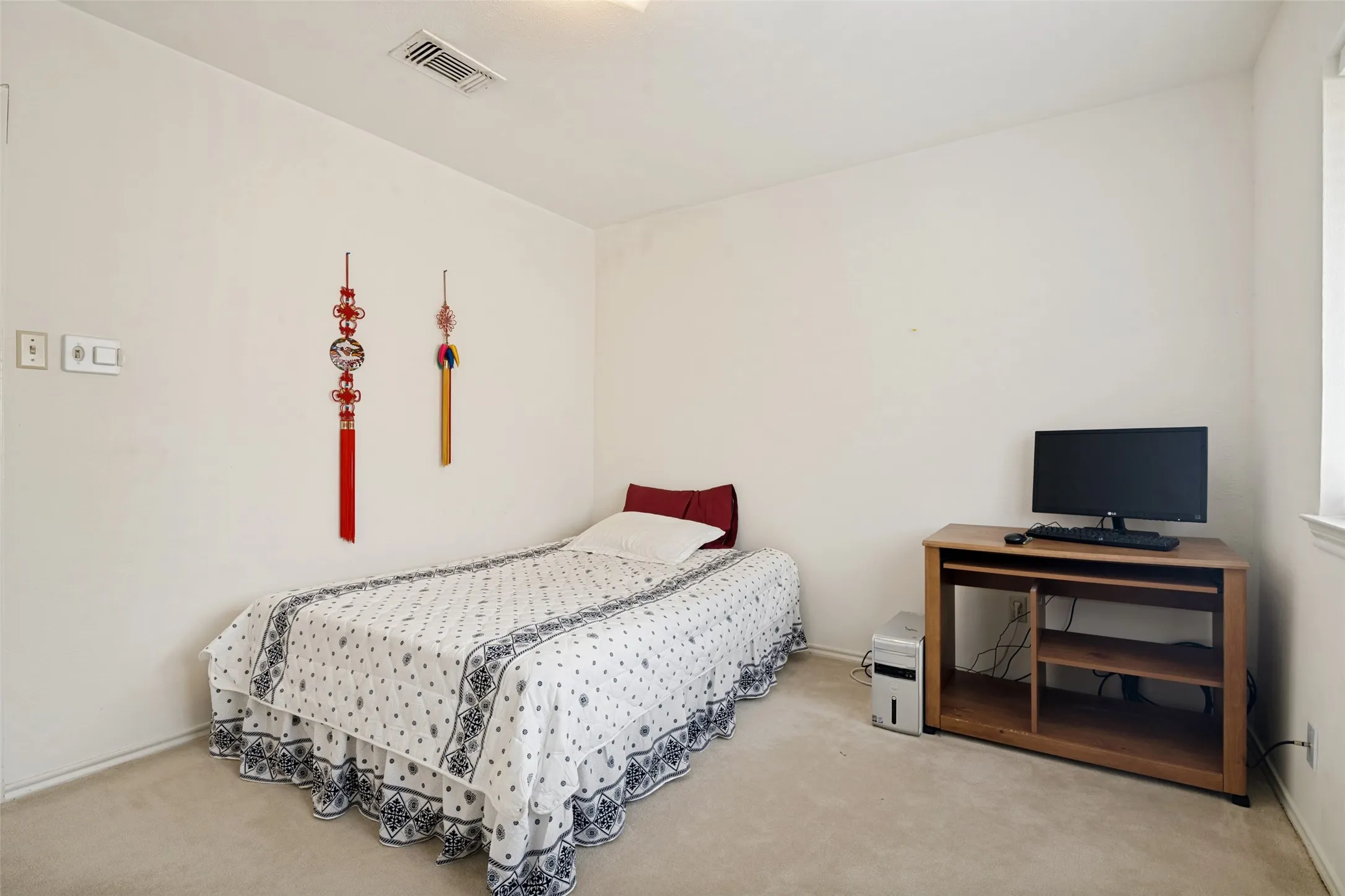 Carpeted room with white walls, recessed lighting, and a window providing natural illumination