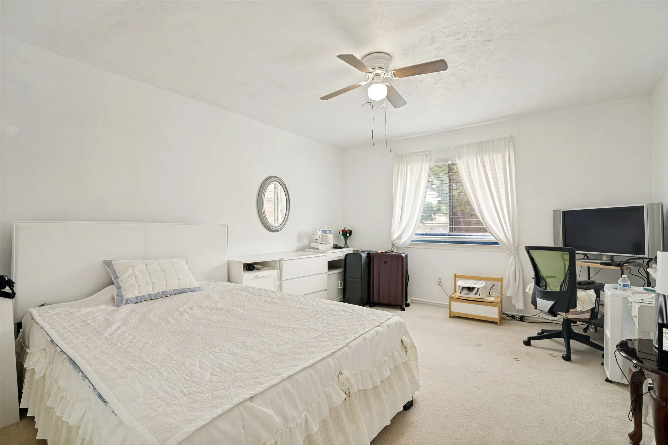 Bedroom featuring neutral carpeting and white walls