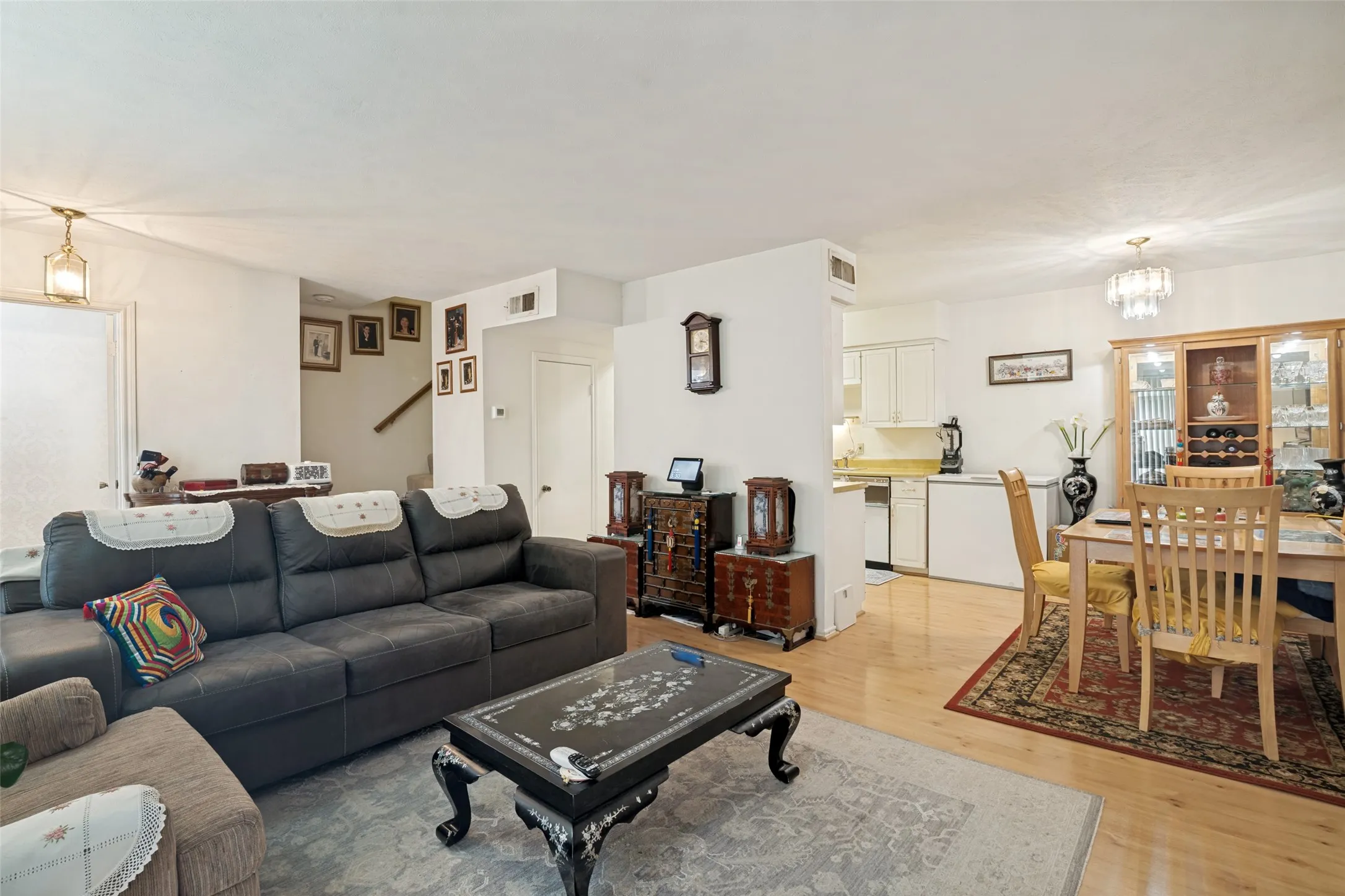 Open-concept living and dining areas featuring wood-finish flooring