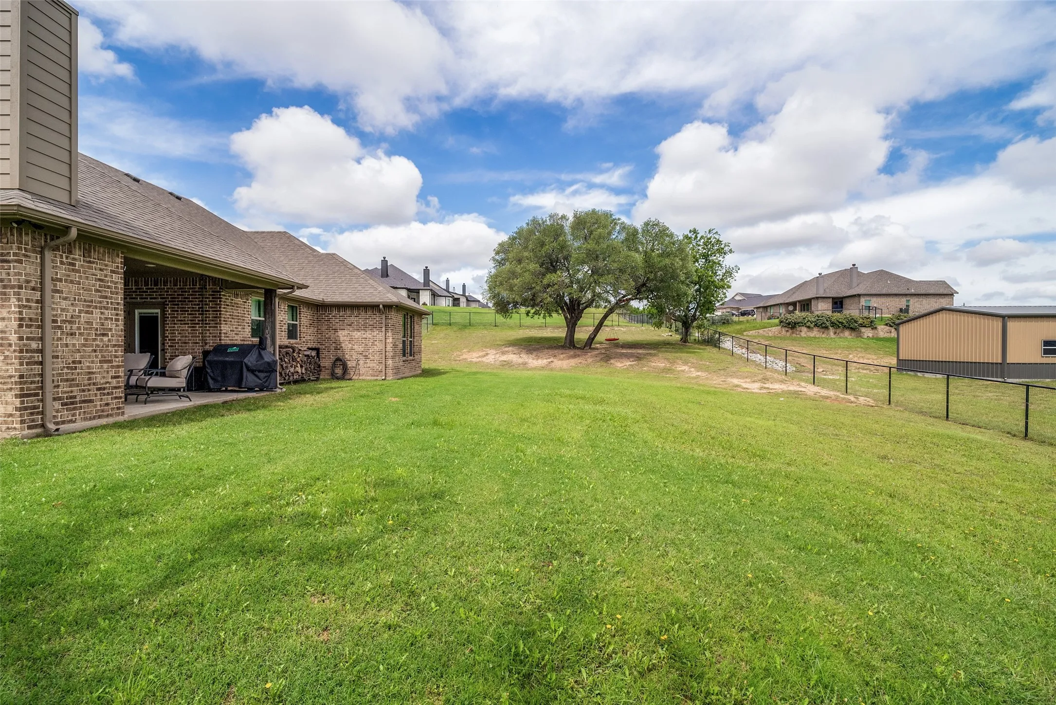 1 acre lot with established grass, backyard perimeter fence and sprinkler system