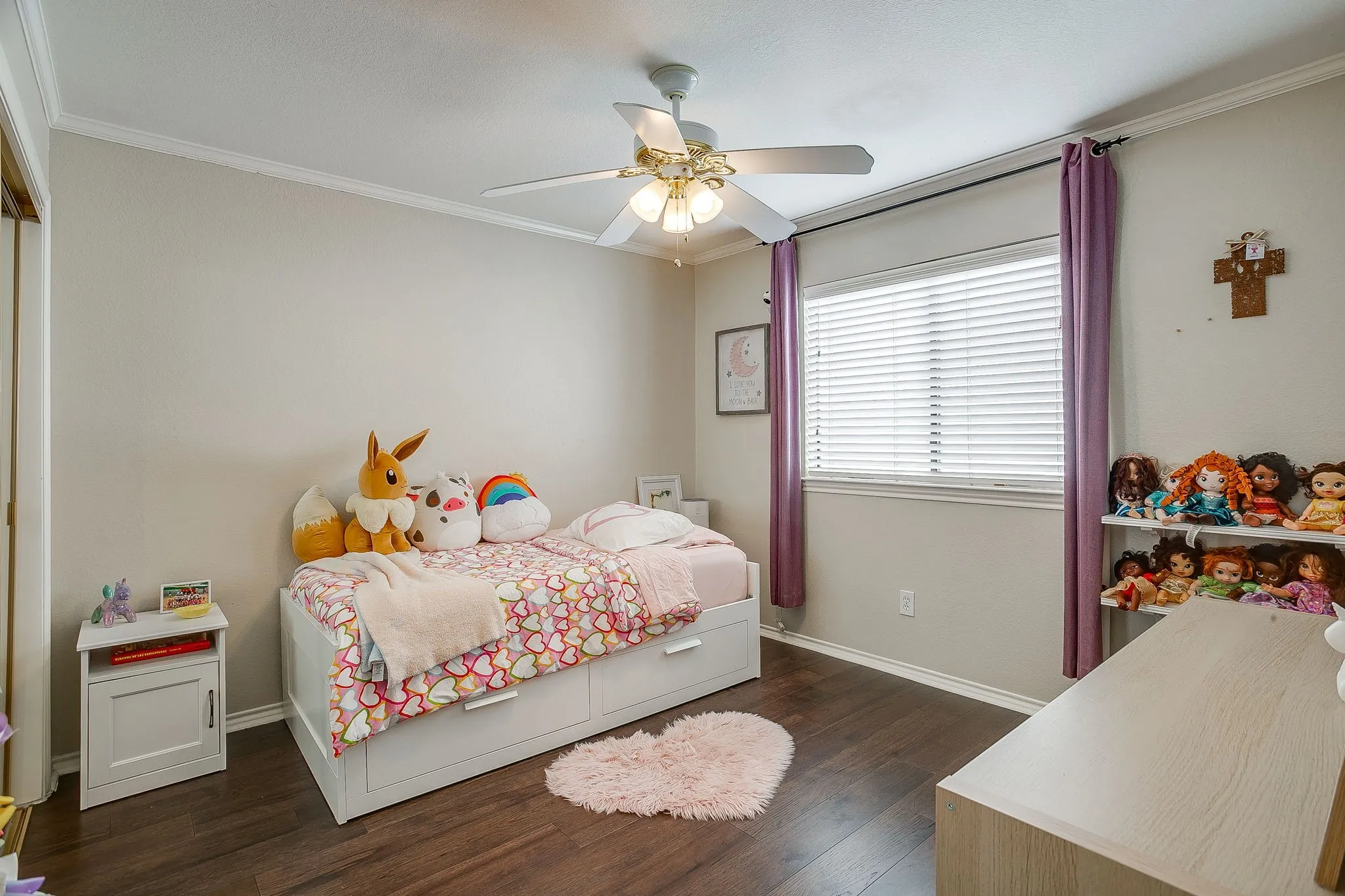 Bright room featuring wood flooring, a ceiling fan with integrated lighting, and a window with blinds