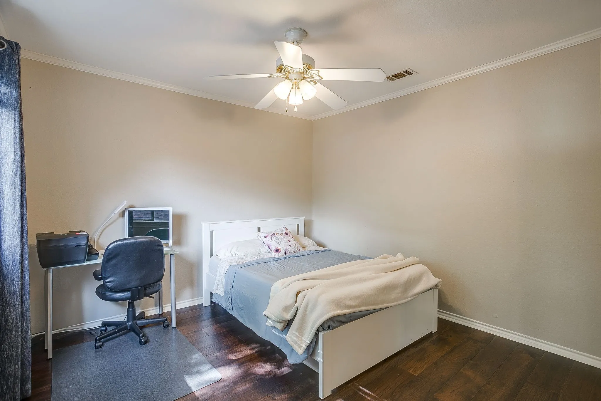 Warm-toned interior with crown molding, ceiling fan with integrated lights and wood flooring