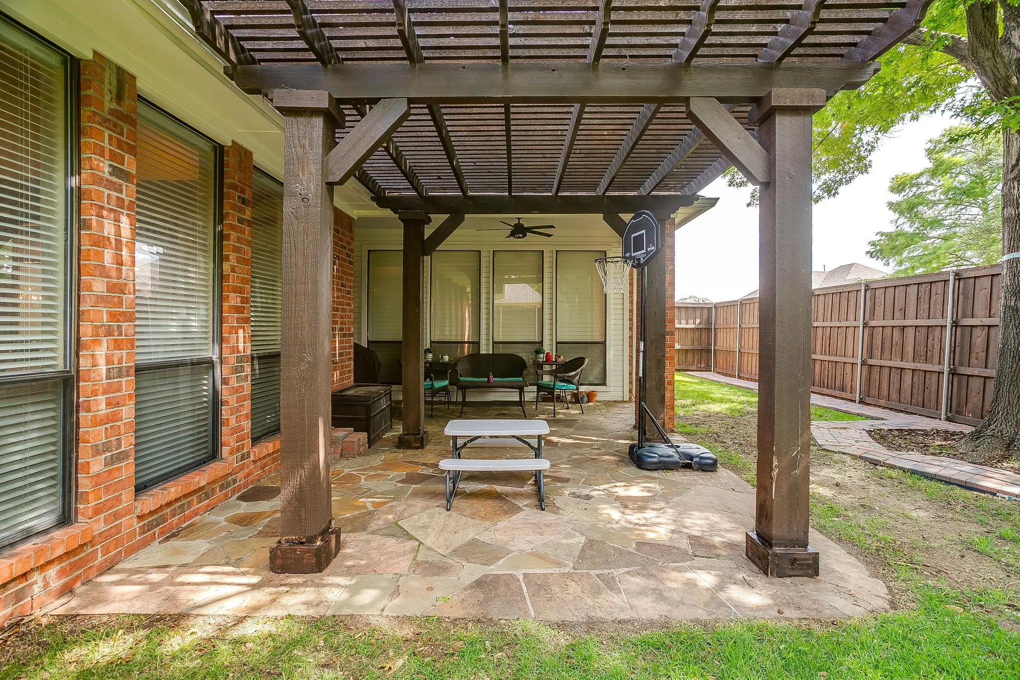 Covered patio featuring a wood pergola and irregular flagstone paving