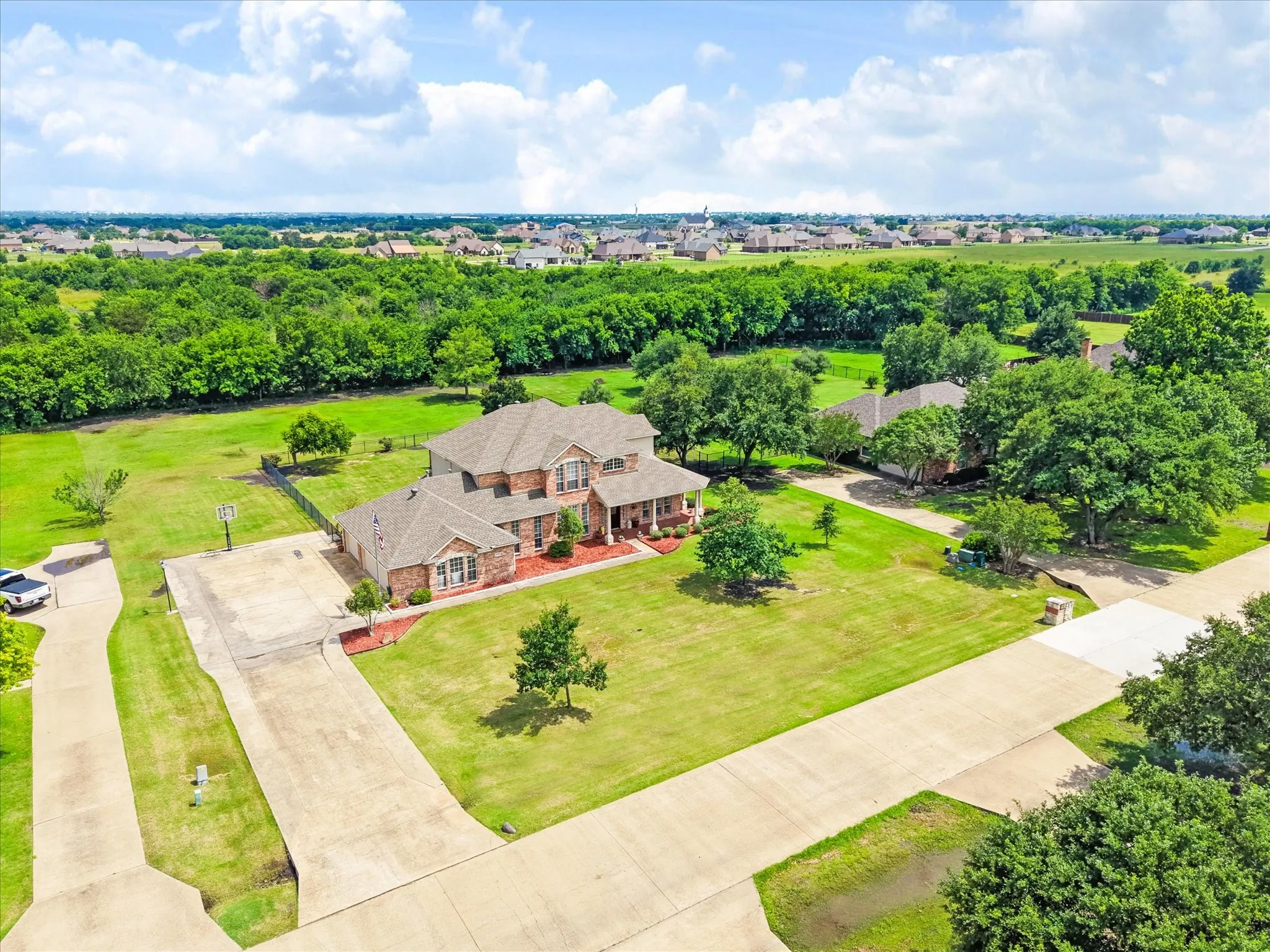 Expansive property featuring a large brick residence with a multi-gabled roofline