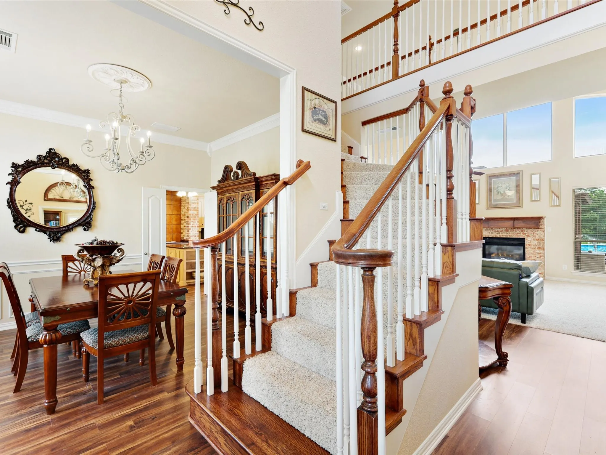 Grand staircase with wood-finish handrails and white balusters