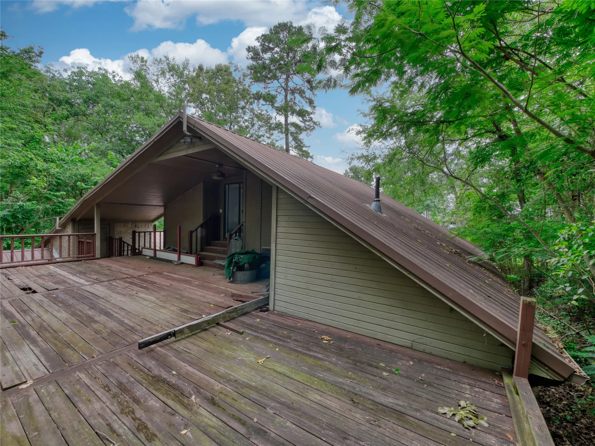 Expansive wood deck with a partial overhang and sloped metal roof