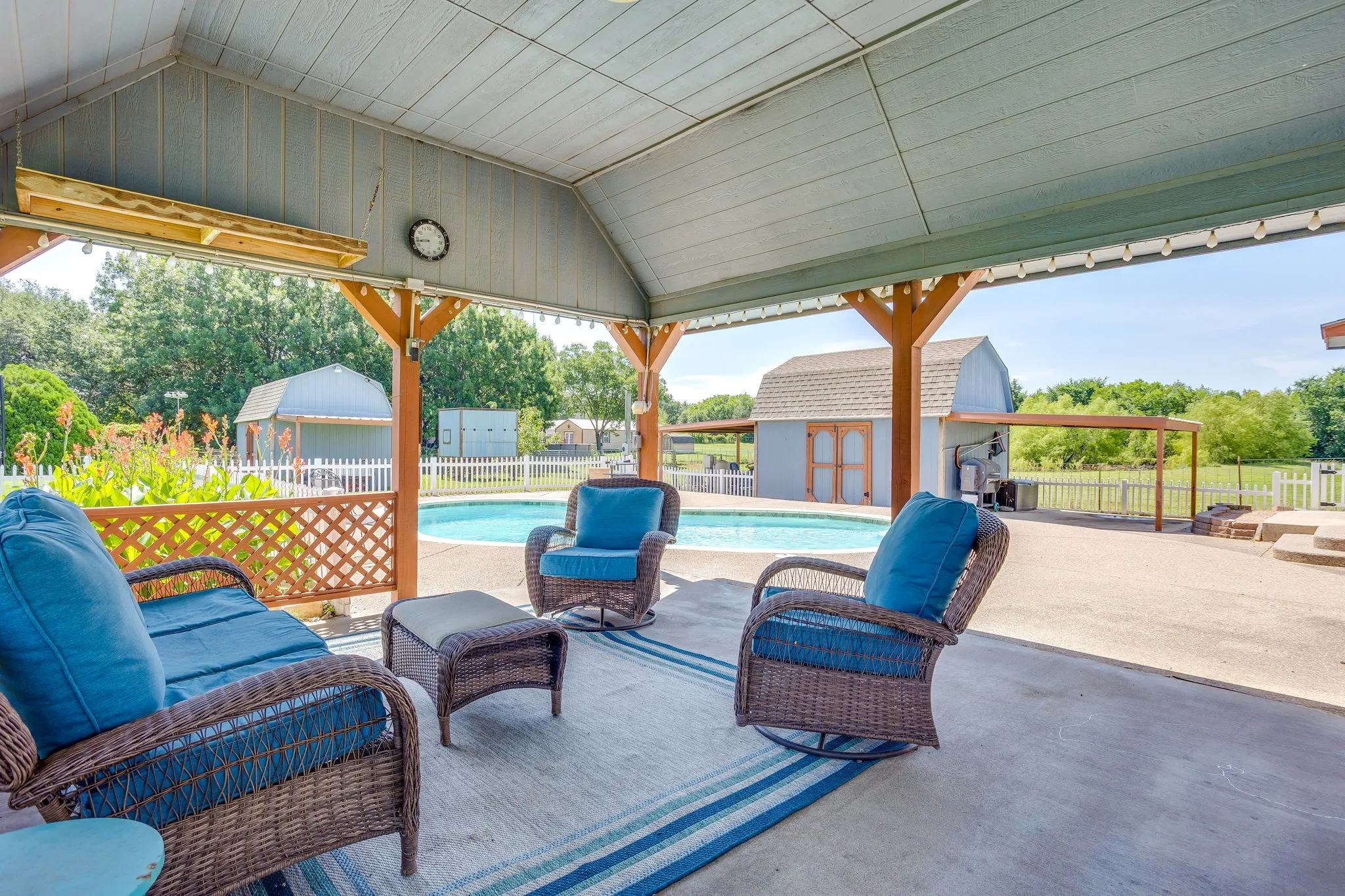 Shaded outdoor living area next to pool