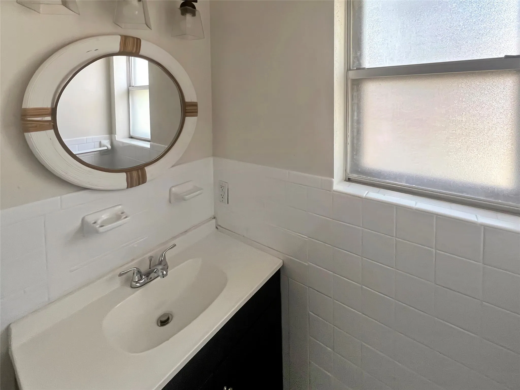 Bathroom vanity with an integrated sink and chrome faucet