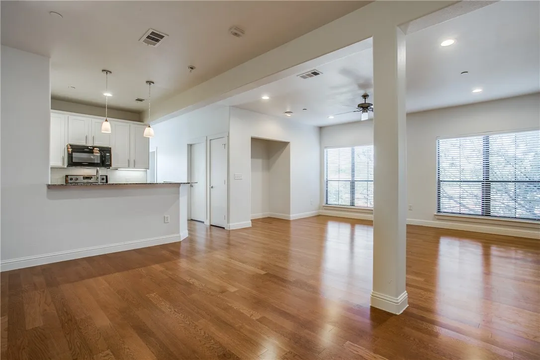 Open floorplan with gleaming hardwood floors.
