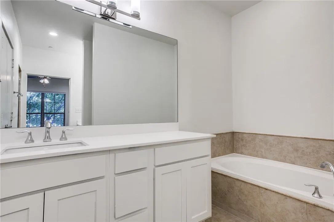 Updated fixtures and large soaking tub complete the master bath