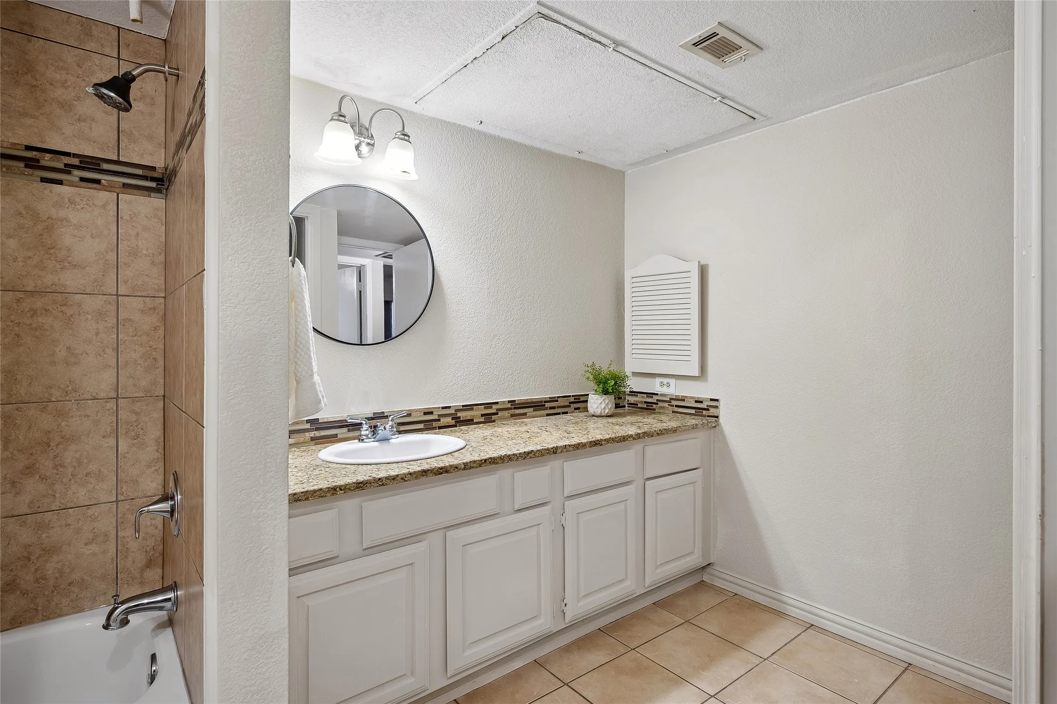 Second full bath with granite vanity counter and update tile in tub/shower area