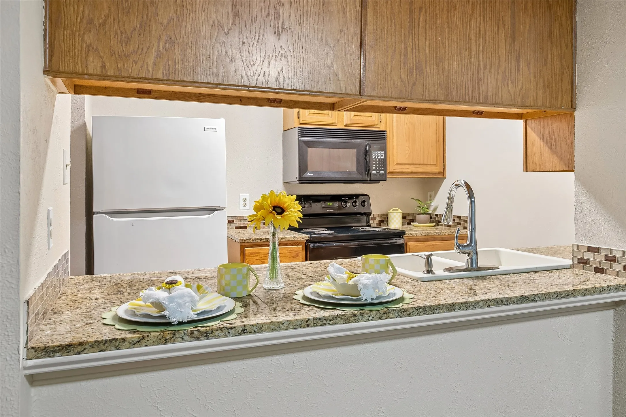 Open serving bar from the kitchen. Granite counters.