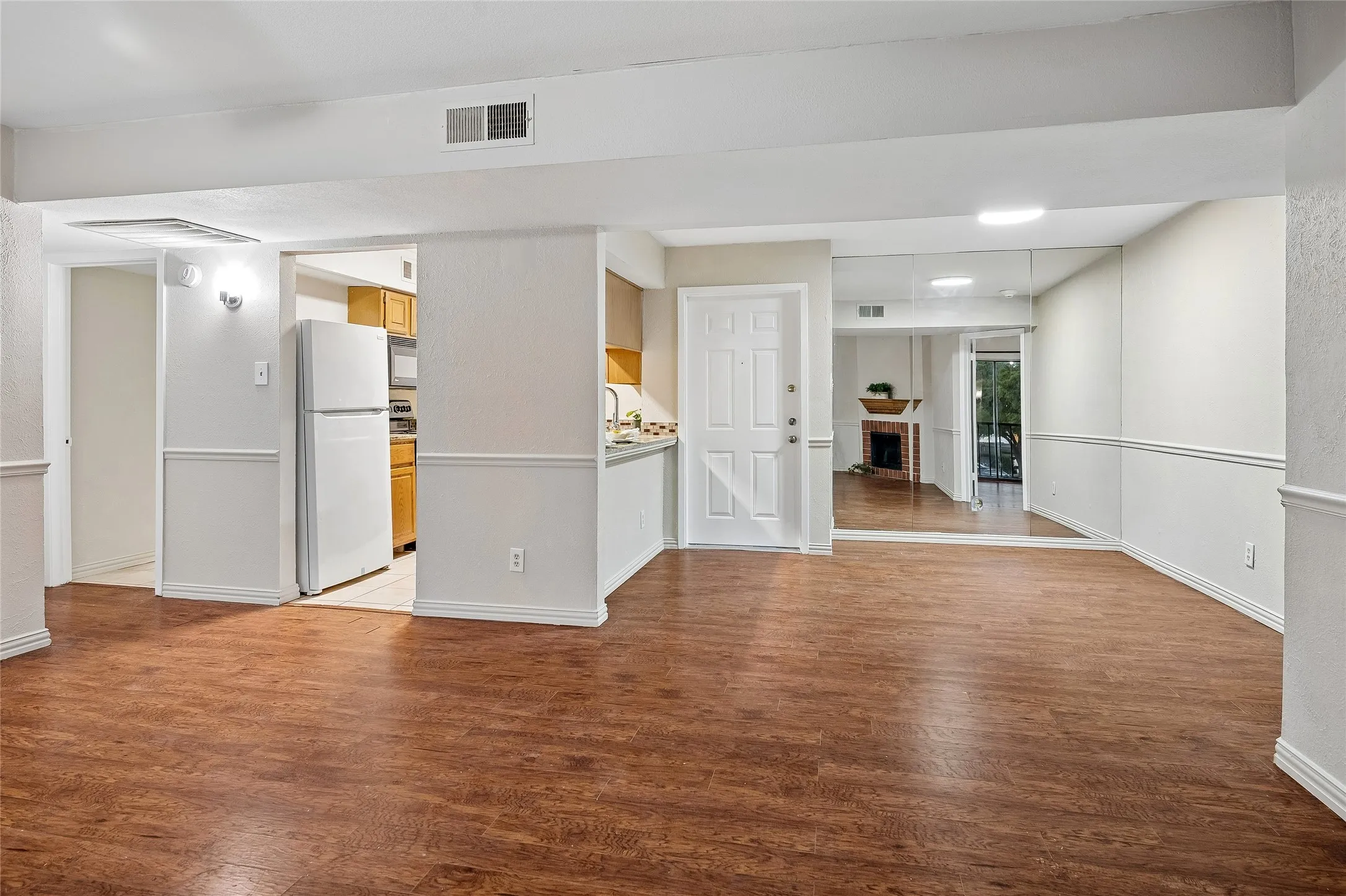 View from Living Room toward entry, dining and kitchen