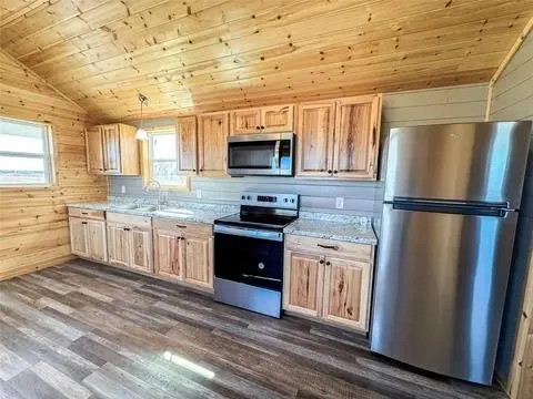 Kitchen featuring knotty wood cabinetry and light-toned countertops