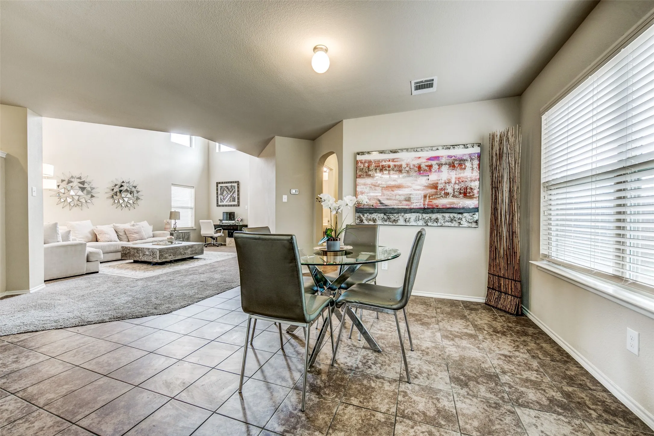Dining area featuring tile flooring, a large window with blinds, and recessed lighting