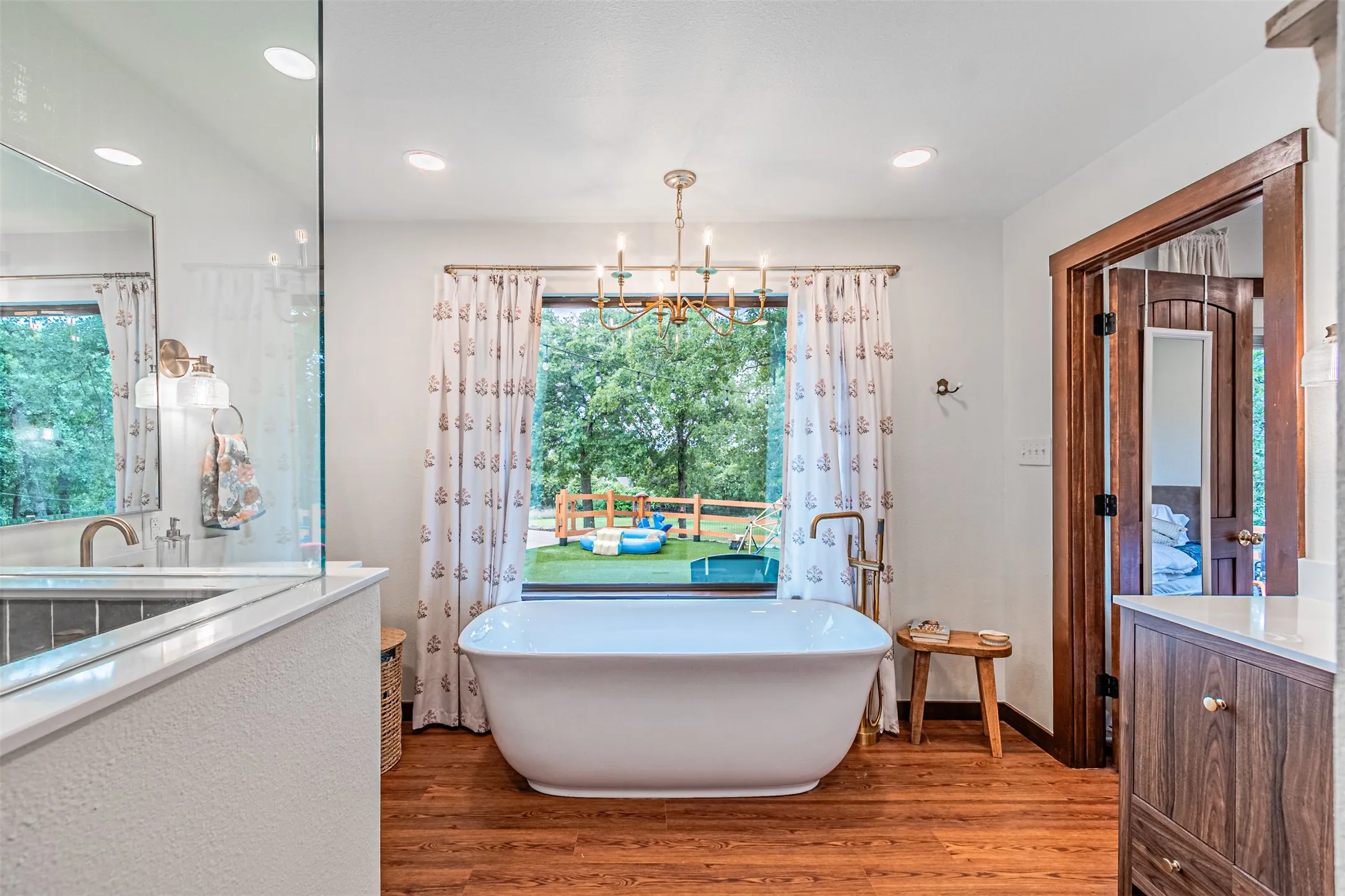 Freestanding soaking tub with floor-mounted faucet