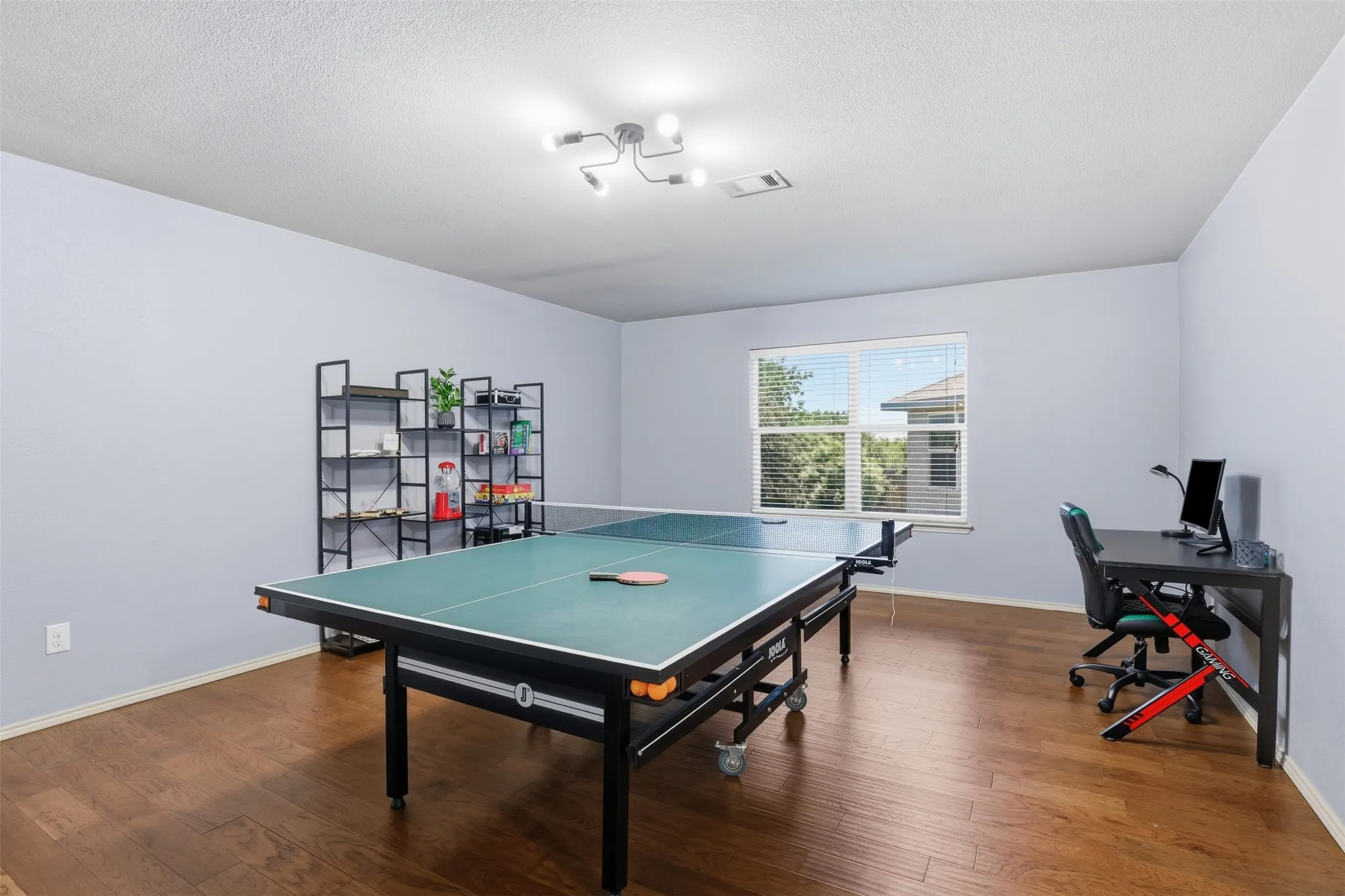 Spacious bonus/game room located on the 2nd floor featuring wood-finish flooring, light blue walls, and a contemporary ceiling light fixture