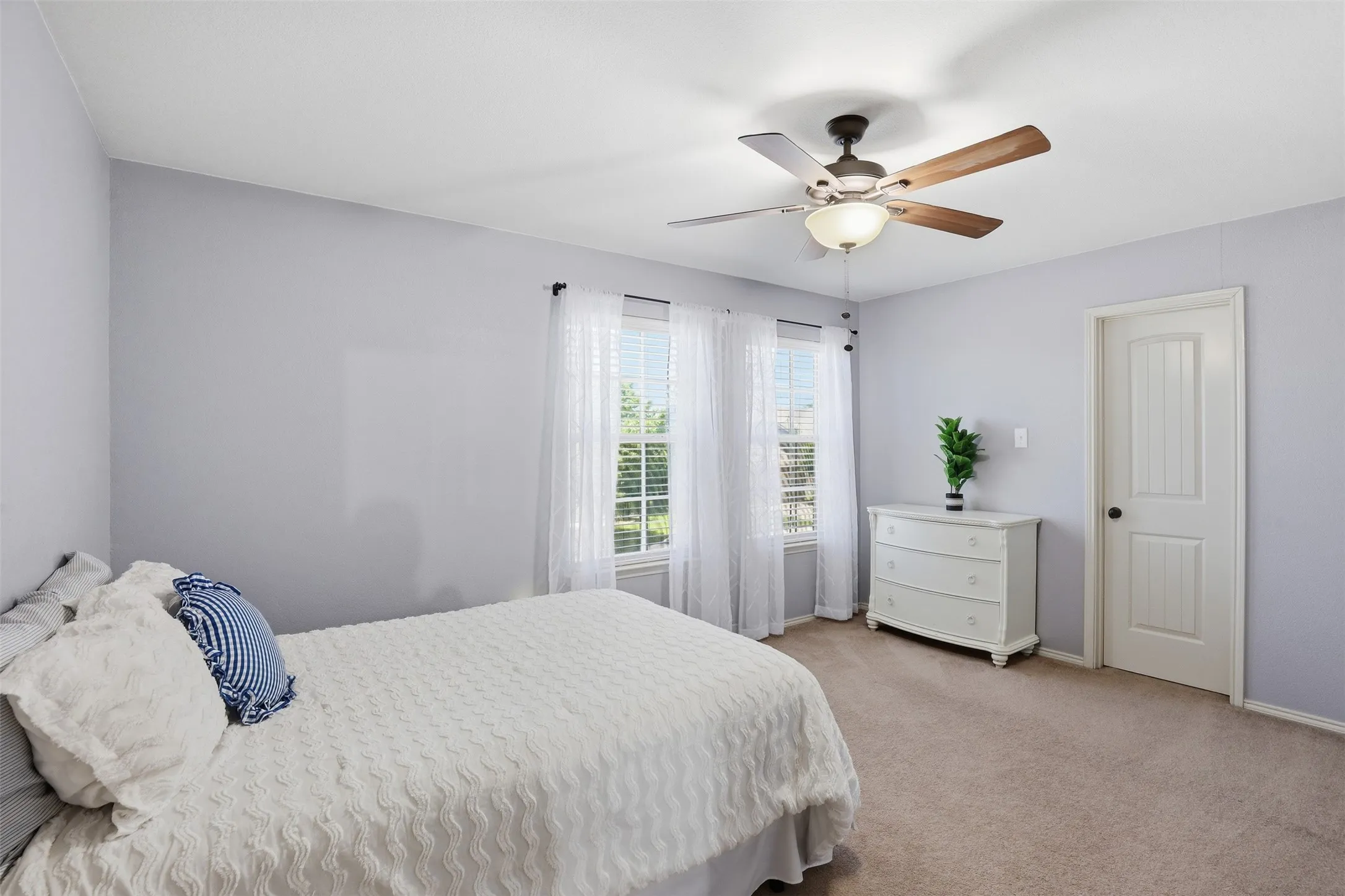Bedroom located on the 2nd floor with a ceiling fan featuring a light fixture and large walk in closet.