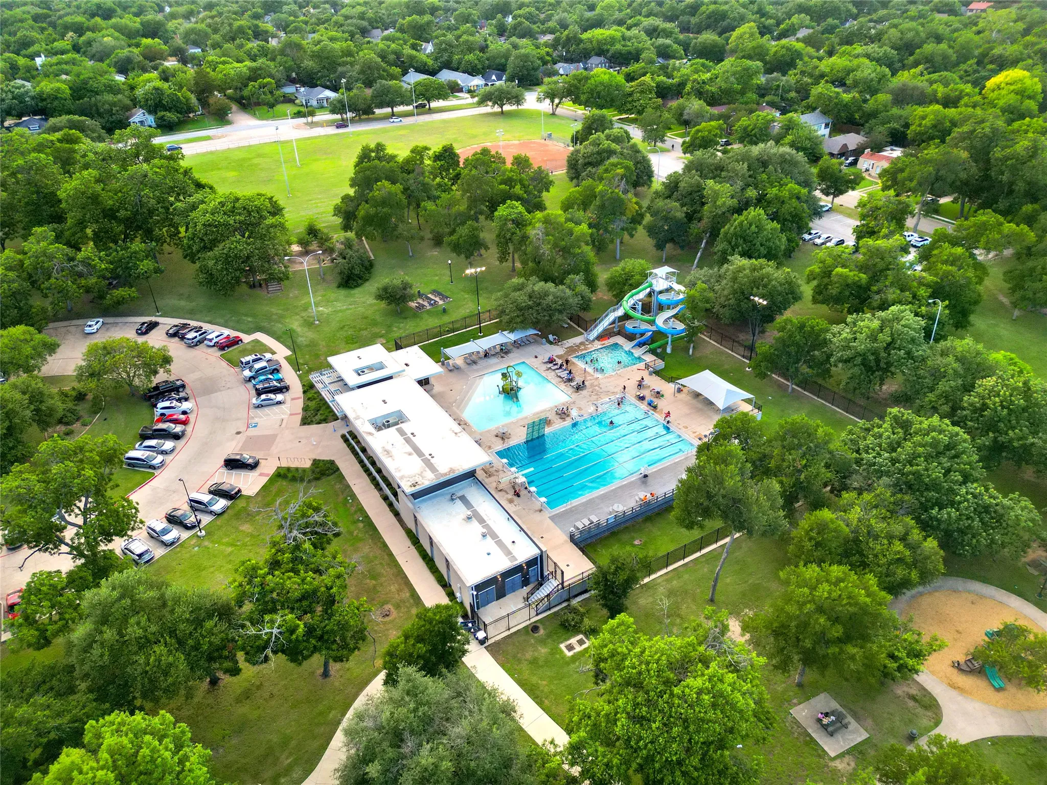 The Kidd Springs Aquatic Center offers resort-style neighborhood recreation with swimming pools, interactive water play areas, slides, and seasonal programming for all ages.